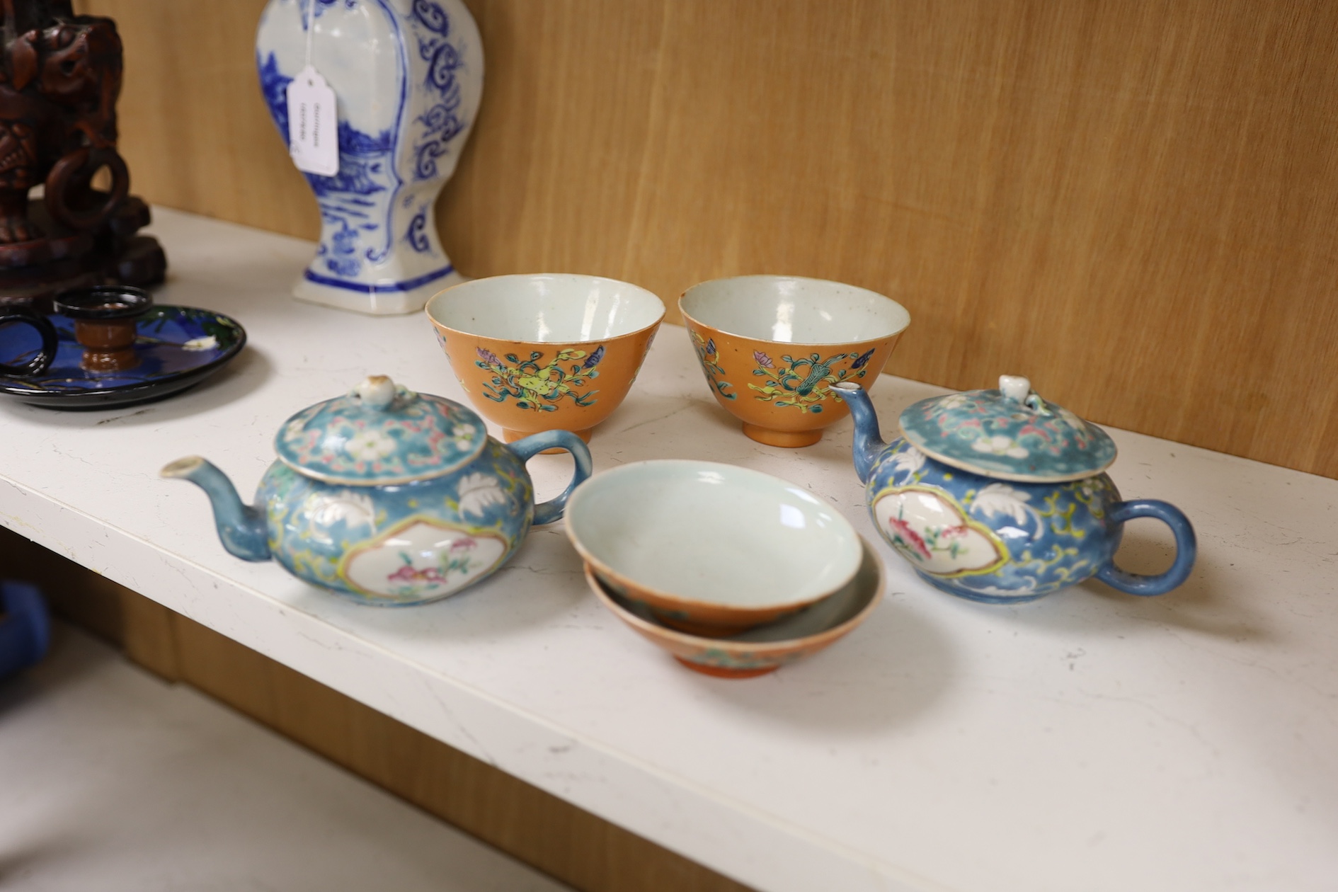 Two Chinese blue ground teapots, Tongzhi mark, and a pair of orange ground bowls and covers, teapots 15cm wide. Condition - fair